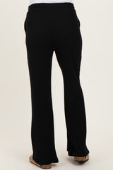 woman wearing black ribbed maternity pants seen from the back