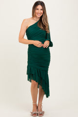 woman wearing a dark green one-shoulder maternity dress with ruched details and ruffle hem, holding her baby bump