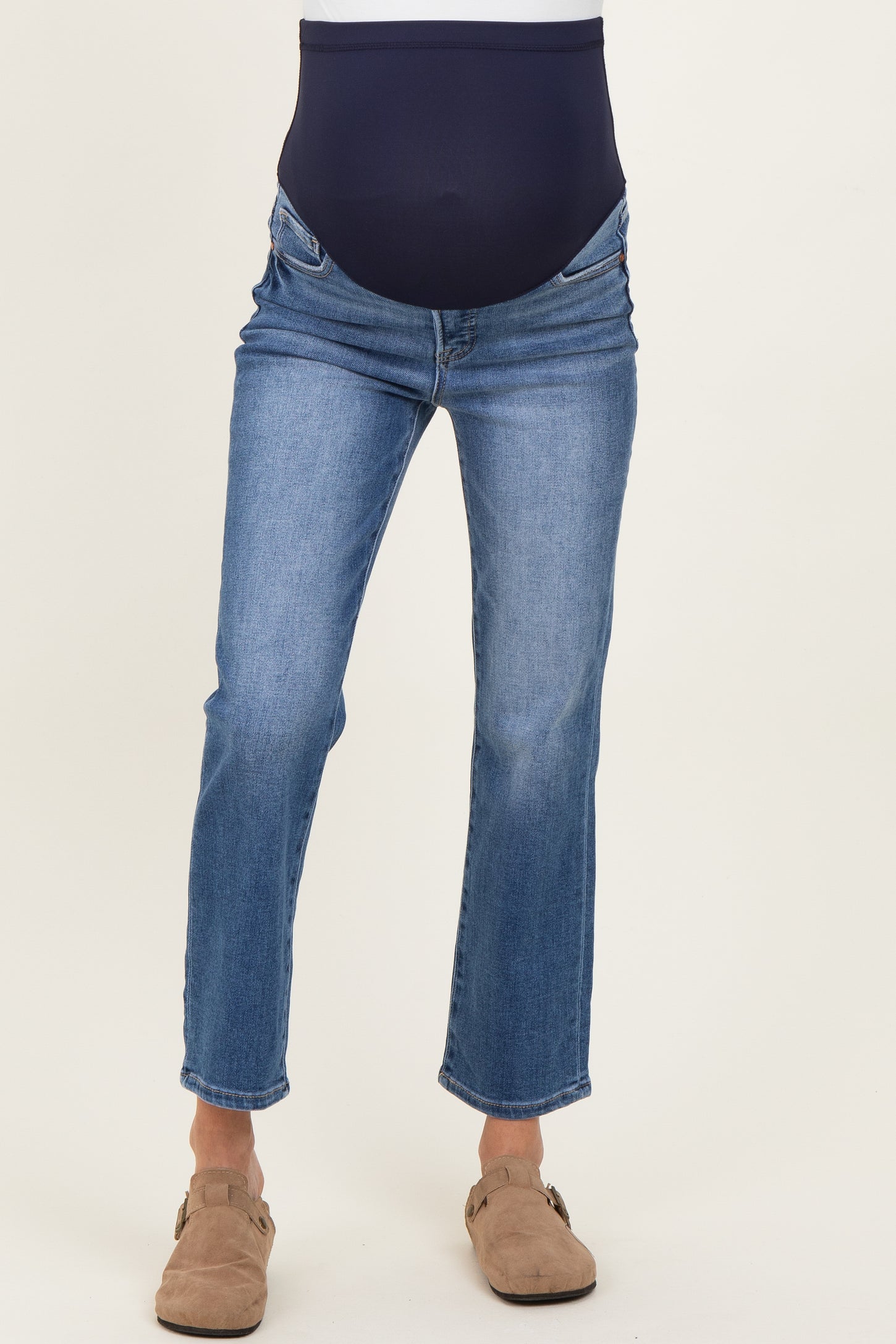 woman wearing blue maternity jeans with a navy belly band and a straight leg cut