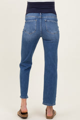 woman wearing a pair of blue maternity jeans with a soft navy waistband from the back