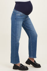woman wearing a pair of blue maternity jeans with a navy belly panel and a visible baby bump