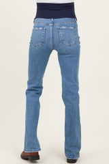 woman wearing light blue maternity bootcut jeans with a dark blue waistband, showing the back view