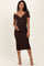 woman wearing a brown off-the-shoulder maternity dress with a fitted silhouette and holding her baby bump