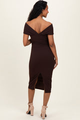 woman wearing a brown off-shoulder maternity dress with a fitted silhouette and a back slit