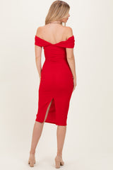 woman wearing a red off-the-shoulder midi dress with a fitted silhouette and a back slit
