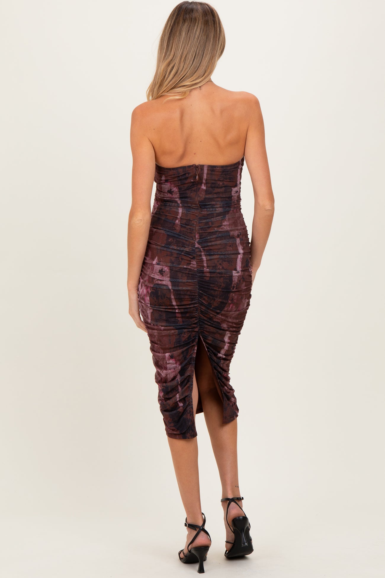 maternity wear dark maroon strapless dress with ruching and a side slit, model viewed from the back