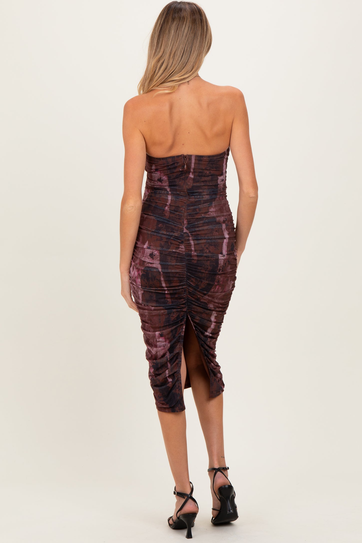 maternity wear dark maroon strapless dress with ruching and a side slit, model viewed from the back