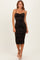 woman wearing a black and orange ruched bodycon midi dress with thin straps and a sweetheart neckline