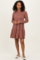 woman wearing a brown striped long sleeve dress with a tiered skirt and white slip-on shoes