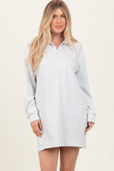woman wearing a light gray long sleeve pullover dress with a half zipper and relaxed fit