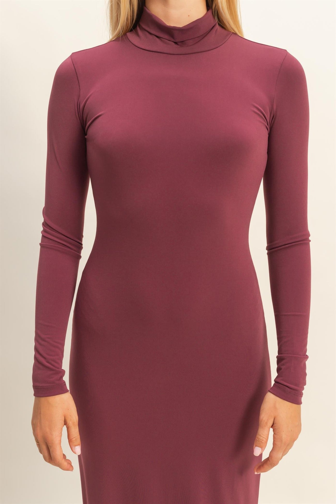 woman wearing a burgundy long sleeve turtleneck dress