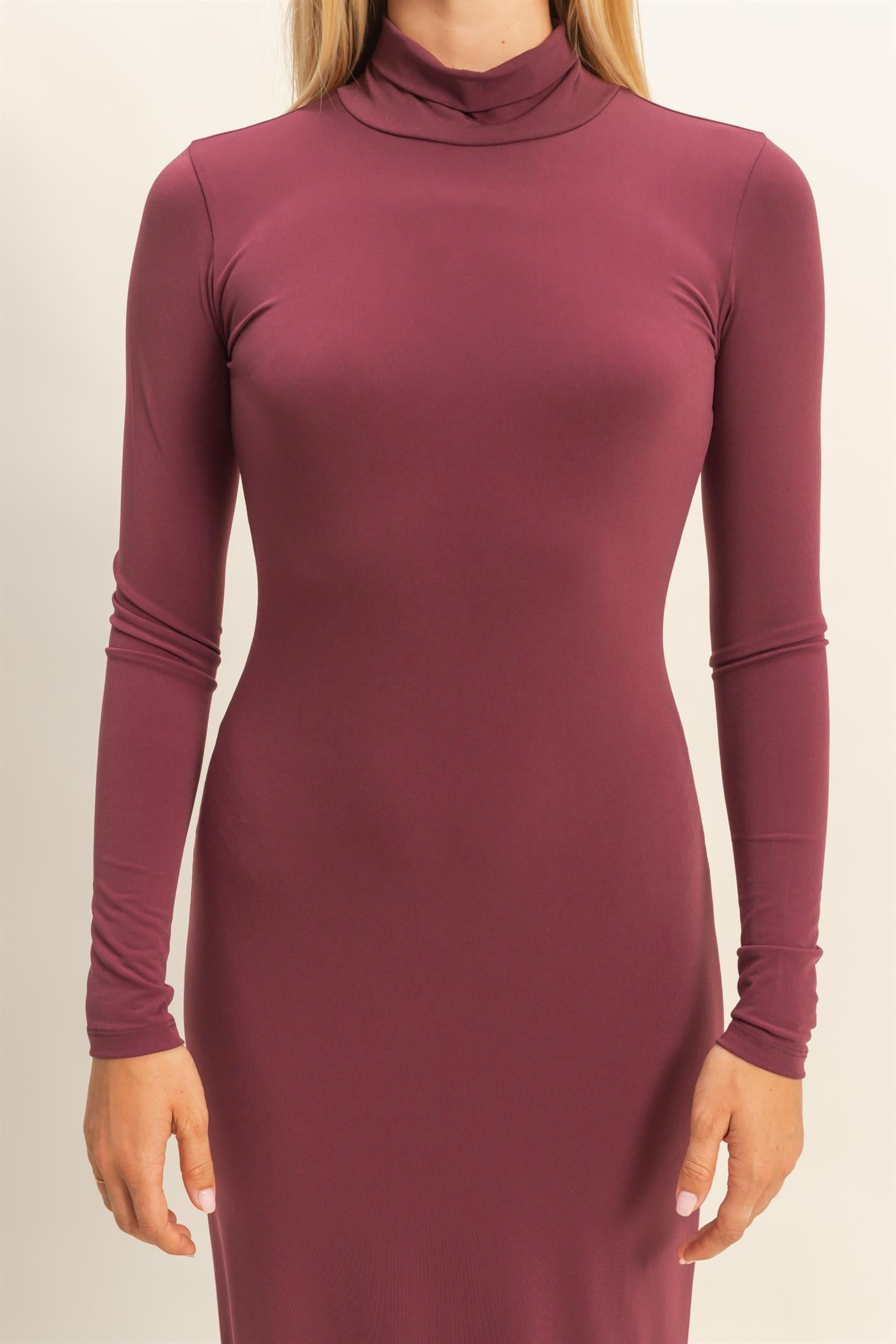 woman wearing a burgundy long sleeve turtleneck dress