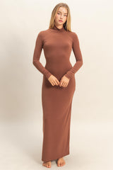 woman wearing a brown long sleeve maxi dress with a high neckline