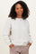 woman wearing a light gray oversized sweatshirt with cuffed sleeves and a round neckline