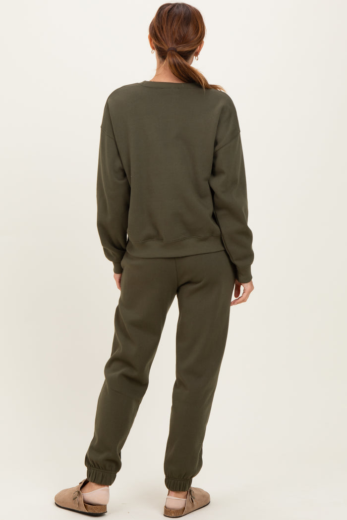 woman wearing an olive green oversized sweatshirt and matching joggers, with a relaxed fit and cuffed ankles