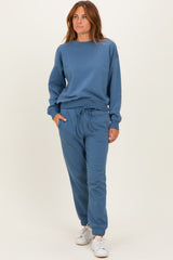 woman wearing a blue matching sweatshirt and jogger set with a relaxed fit and drawstring waistband