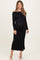woman wearing a black off-the-shoulder maternity maxi dress showing her baby bump
