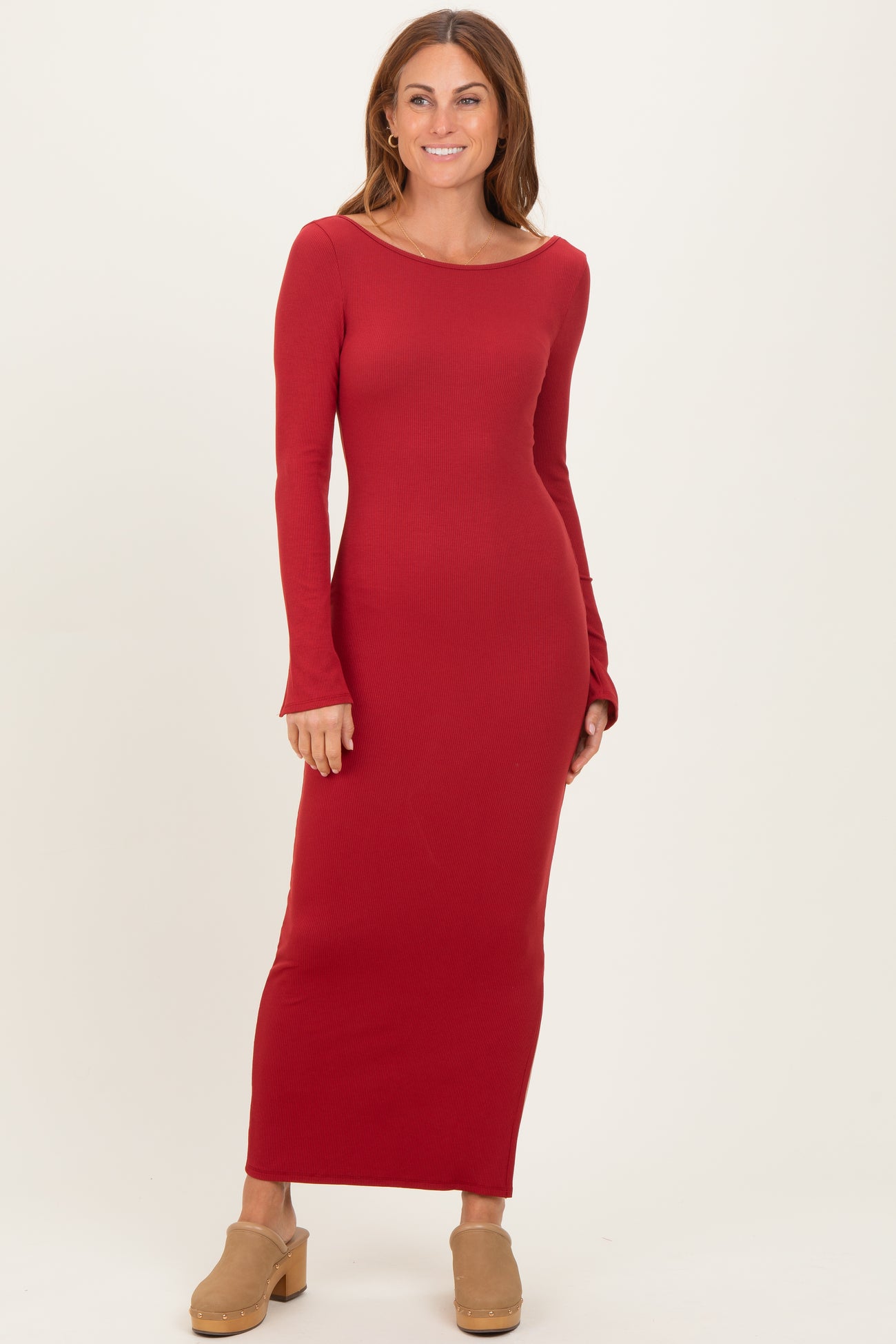 woman wearing a long red ribbed maxi dress with long sleeves and a scoop neckline