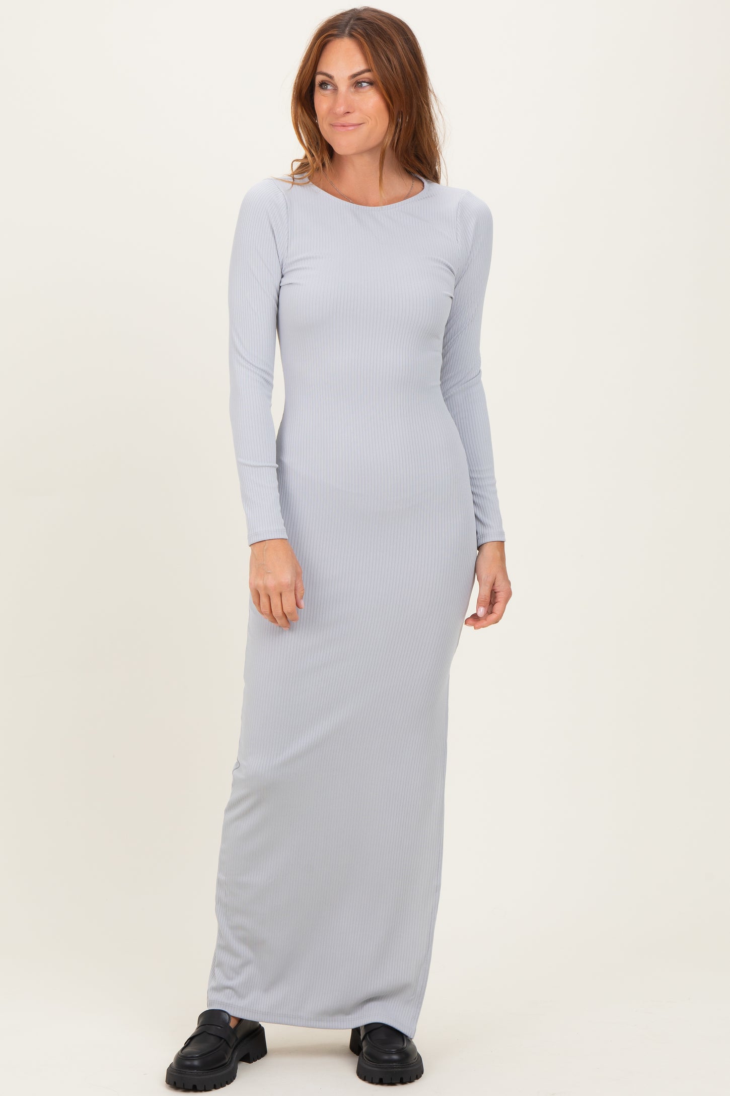 woman wearing a light gray ribbed maxi dress with long sleeves and a relaxed fit