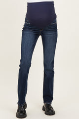 woman wearing dark blue maternity jeans with a supportive belly panel and black ankle boots