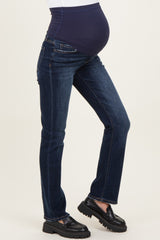 woman wearing dark blue maternity jeans with a stretchy navy waistband and black platform loafers, showcasing her baby bump