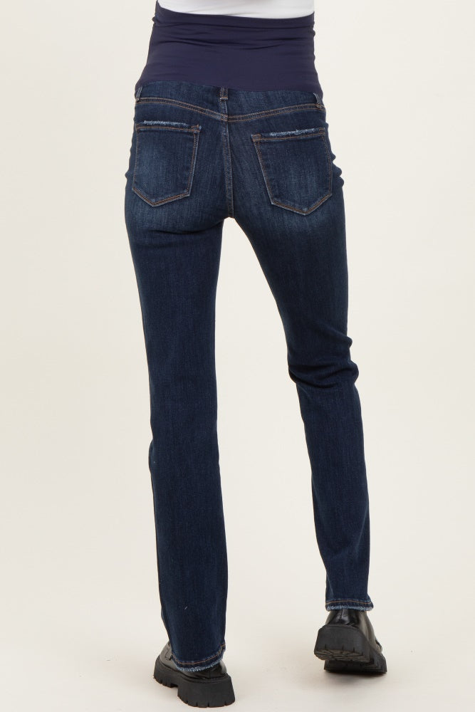 woman wearing dark blue maternity jeans, showing the back view with a slightly flared leg and elastic waist band