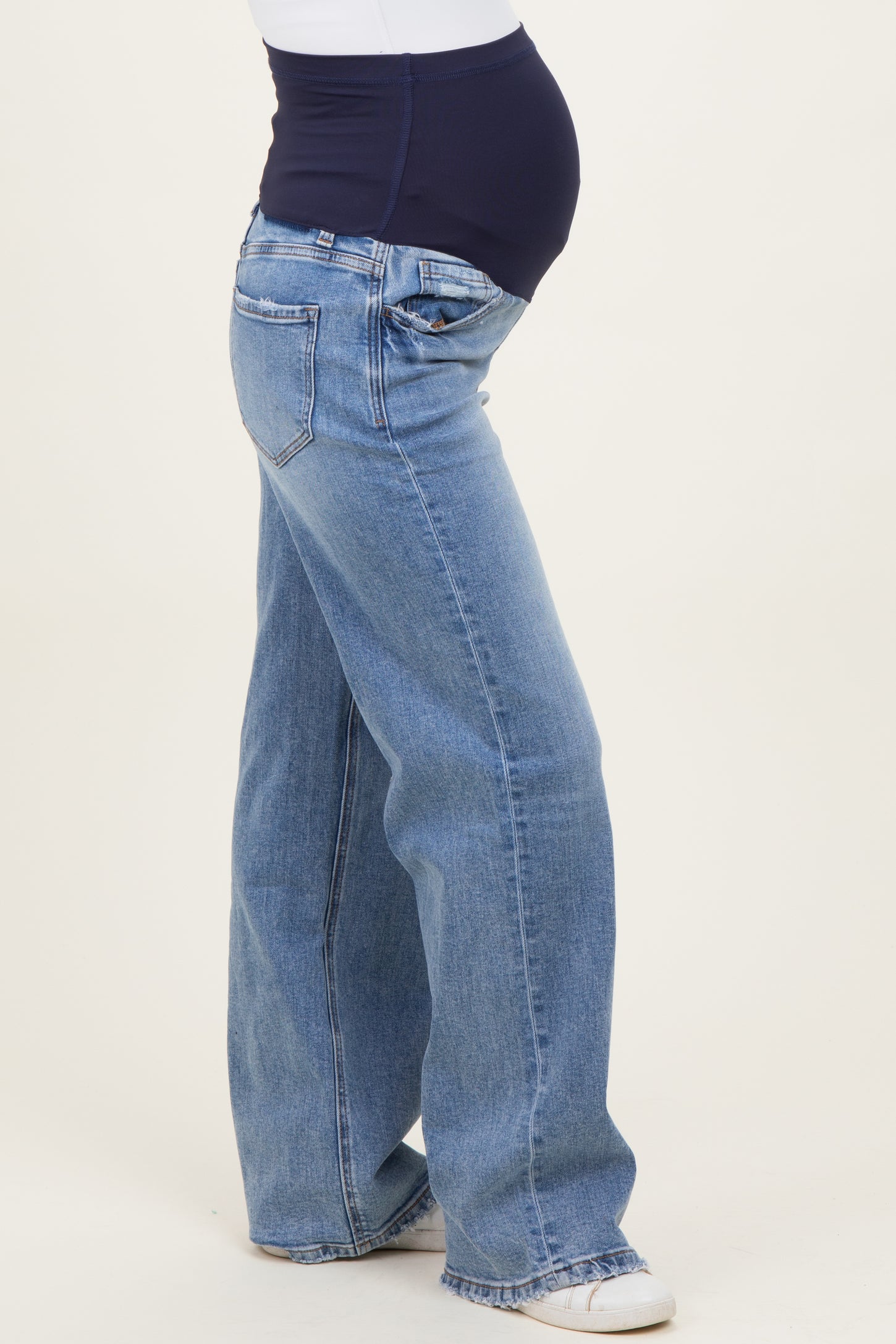maternity wear dark blue over-the-bump jeans with a relaxed fit, model showing baby bump from the side
