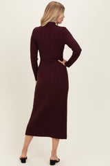 woman wearing a burgundy ribbed midi dress with long sleeves and a fitted silhouette, seen from the back