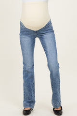 woman wearing light blue maternity jeans with a stretchy beige belly panel