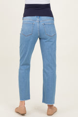 woman wearing light wash maternity jeans with a stretchy navy waistband and cropped hem, showing the back view