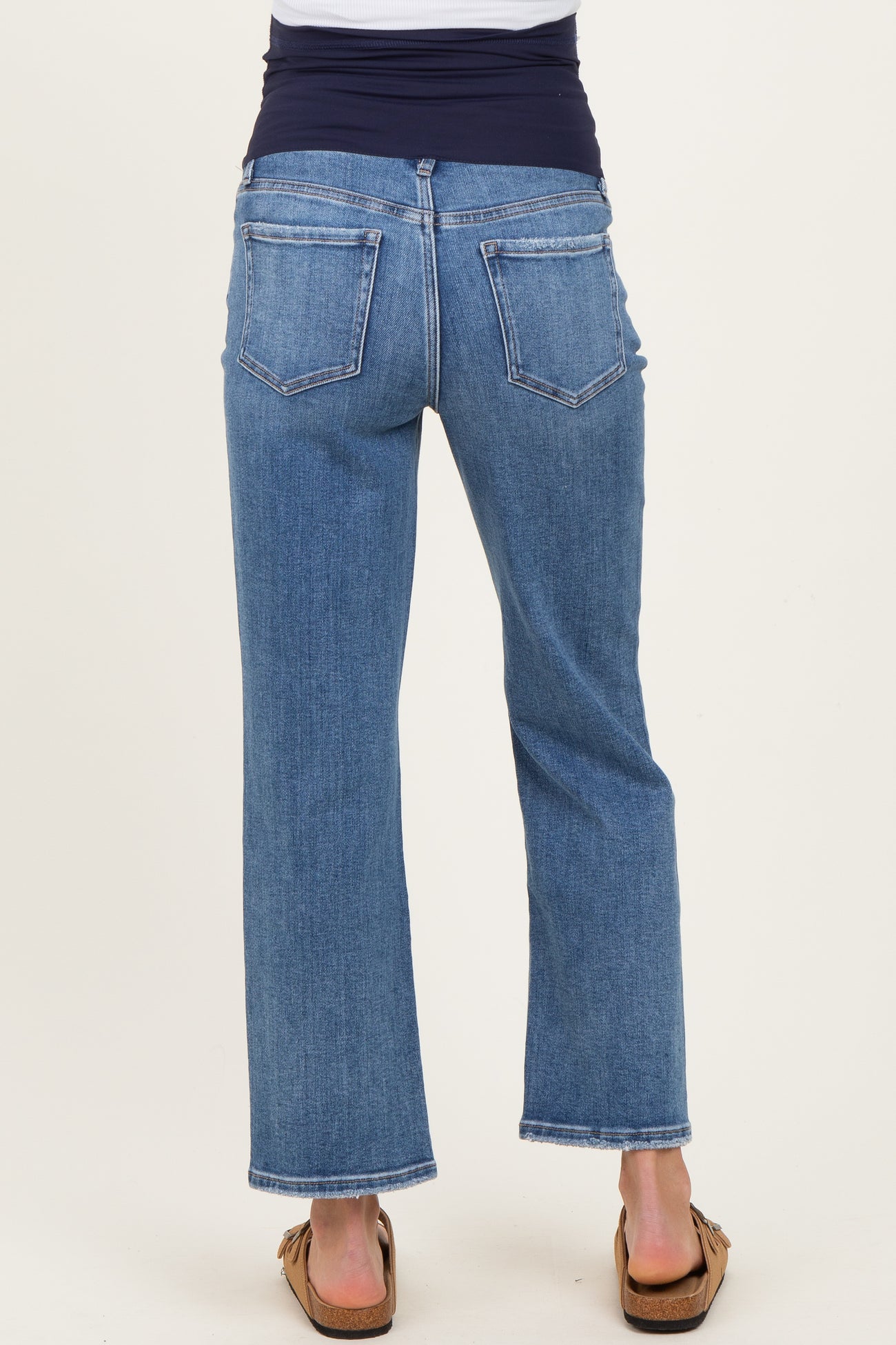 woman wearing maternity denim jeans with a straight leg and a supportive waistband, facing away from the camera