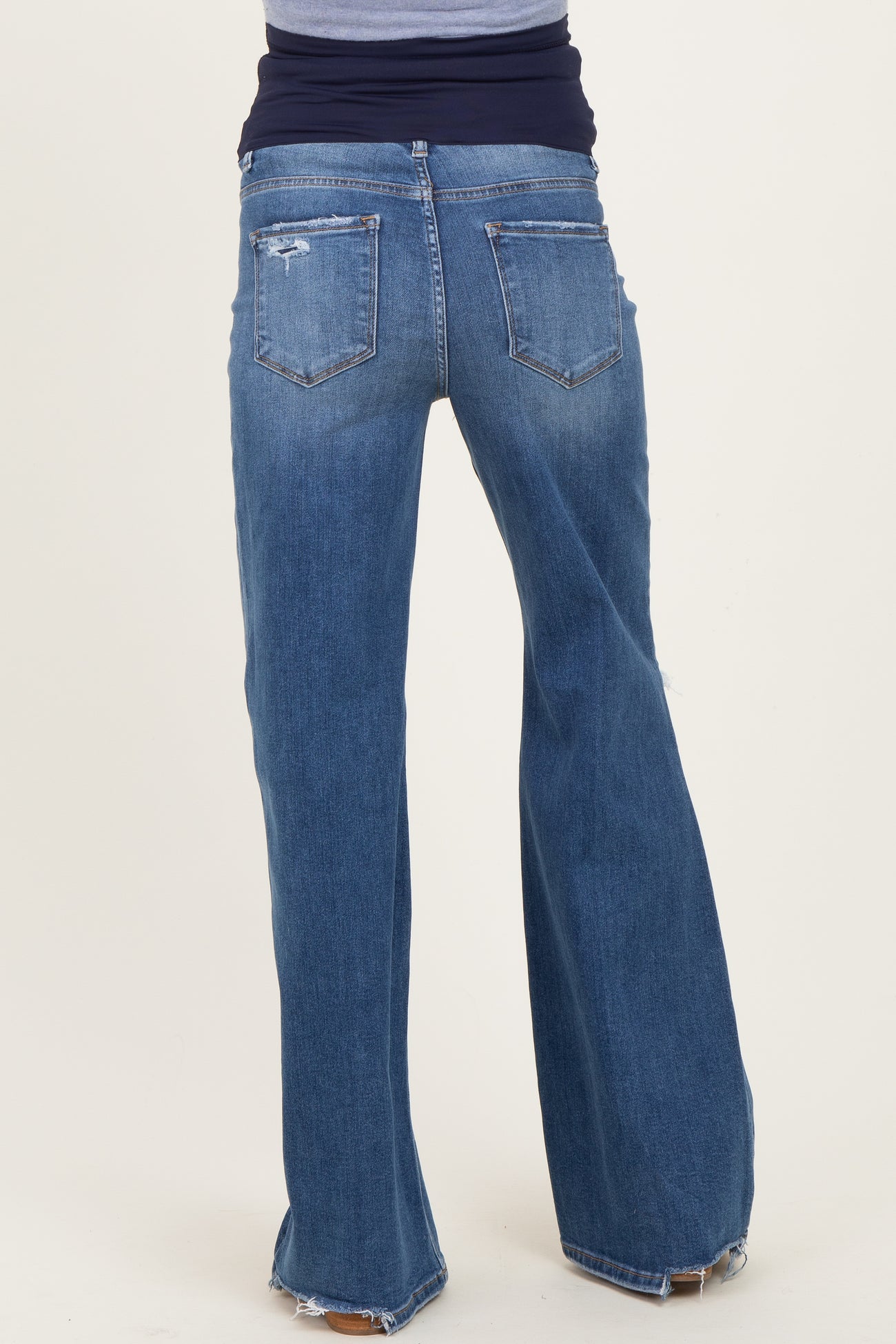 maternity wear blue flared jeans with a high waistband, model seen from behind