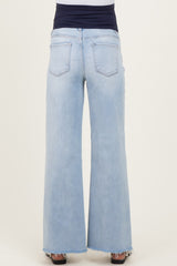woman wearing light blue maternity wide-leg jeans with a raw hem and a navy blue waistband