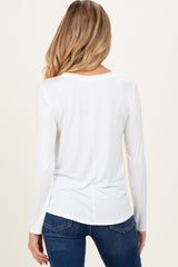 woman wearing a white long sleeve maternity top, showing the back view, paired with blue jeans