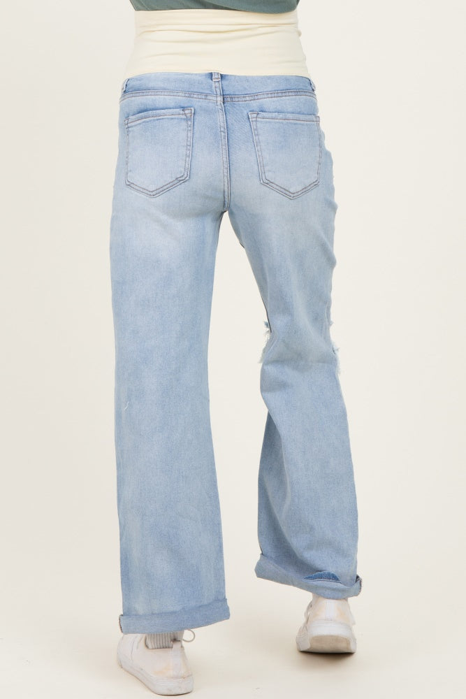 woman wearing light blue maternity jeans with a relaxed fit and roll-up cuffs, seen from the back
