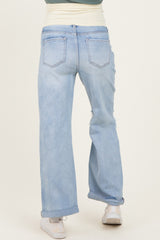 woman wearing light blue maternity jeans with a relaxed fit and roll-up cuffs, seen from the back