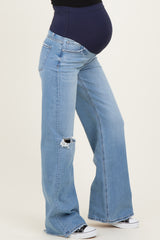 maternity wear light blue distressed wide-leg jeans with a high waistband and visible baby bump