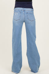 woman wearing a pair of light blue maternity jeans with a relaxed fit and distressed details, viewed from the back