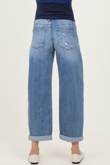 woman wearing light blue maternity wide-leg jeans, shown from the back with rolled cuffs and a distressed detail