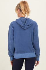 woman wearing a blue maternity hoodie with a relaxed fit and a hood, seen from the back