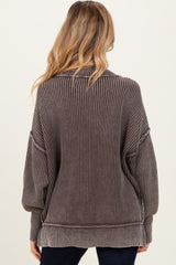 woman wearing a brown striped oversized maternity sweater, view from the back