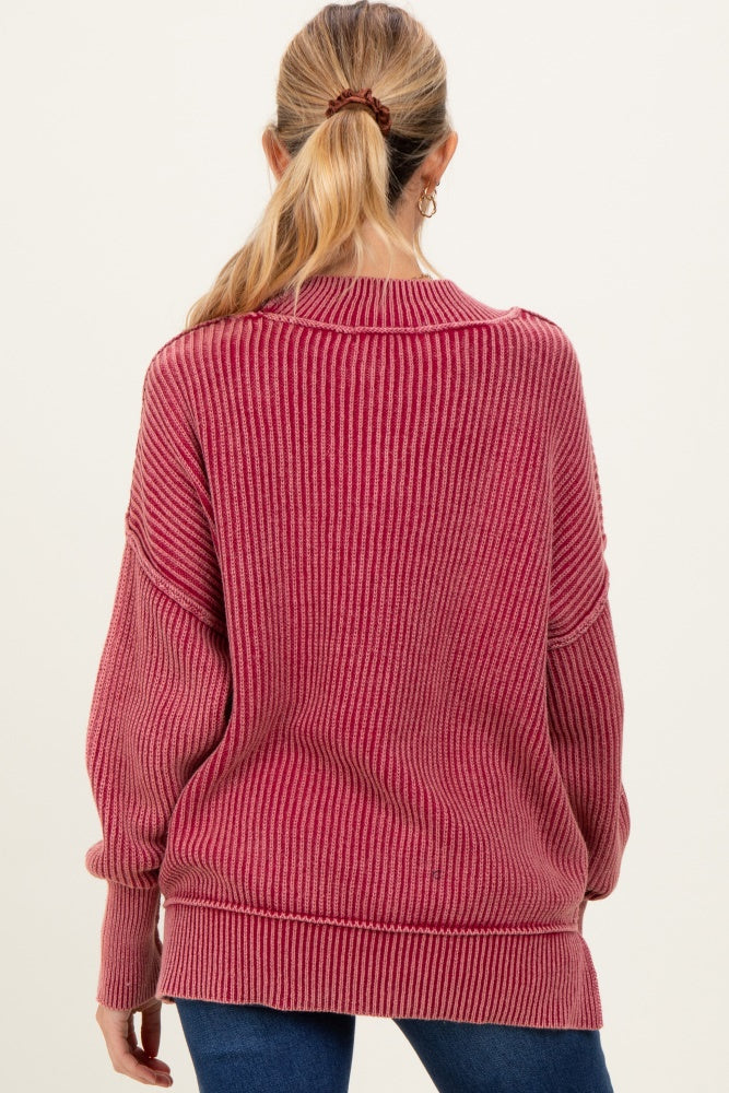 woman wearing a burgundy striped oversized maternity sweater viewed from the back