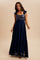 woman wearing a navy blue maxi dress with sequined bodice and ruffled sleeves