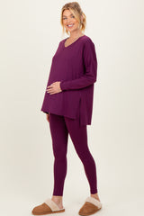 woman wearing a purple maternity lounge set with a long sleeve top and leggings, highlighting her baby bump