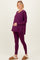 woman wearing a purple maternity lounge set with a long sleeve top and leggings, highlighting her baby bump