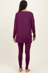 woman wearing a long purple tunic top and matching purple leggings, shown from the back