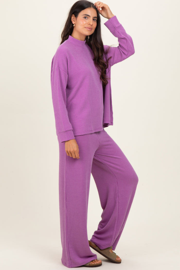 woman wearing a purple ribbed loungewear set with a mock neck top and wide-leg pants