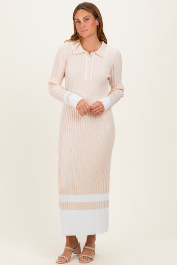 woman wearing a beige ribbed long sleeve maxi dress with white stripe details and a collared neckline