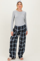 woman wearing a grey long sleeve maternity top and relaxed fit plaid maternity pajama pants with a headband