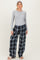 woman wearing a grey long sleeve maternity top and relaxed fit plaid maternity pajama pants with a headband